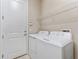 Laundry room featuring a washer and dryer and a wire rack shelf at 15528 Corona Del Mar Dr, Wimauma, FL 33598