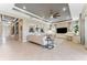 Bright open floor plan living room featuring tile floors, recessed lighting, tray ceiling, and piano at 15528 Corona Del Mar Dr, Wimauma, FL 33598