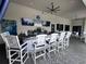 Stylish outdoor bar at Bistro Del Sol featuring white chairs and flat screen televisions at 15528 Corona Del Mar Dr, Wimauma, FL 33598