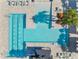 Aerial shot of a community pool showcasing lap lanes, sunbathing areas, and lush landscaping at 15528 Corona Del Mar Dr, Wimauma, FL 33598
