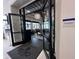 Elegant entrance to the Bistro Del Sol restaurant featuring glass doors and a stylish overhead light fixture at 15528 Corona Del Mar Dr, Wimauma, FL 33598