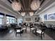 Bistro Del Sol restaurant interior with tables set in a bright open space with modern light fixtures at 15528 Corona Del Mar Dr, Wimauma, FL 33598