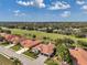 Stunning aerial view of the home with a terracotta tile roof, manicured lawn, and golf course in the background at 1617 El Pardo Dr, Trinity, FL 34655