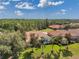 This aerial view captures a neighborhood of tile-roofed homes with lush green lawns and mature trees at 1617 El Pardo Dr, Trinity, FL 34655