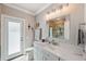 Stylish bathroom features a granite vanity, glass shower door and access to the backyard at 1617 El Pardo Dr, Trinity, FL 34655