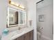 Well lit bathroom features a spacious vanity with marble countertop and a decorative mirror at 1617 El Pardo Dr, Trinity, FL 34655