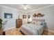 Relaxing bedroom with wood-style floors, ceiling fan, and decorated with unique wall art at 1617 El Pardo Dr, Trinity, FL 34655