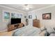 Bright bedroom with large windows, an entertainment center, and cozy coastal decor at 1617 El Pardo Dr, Trinity, FL 34655