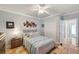 Well-lit bedroom features a ceiling fan, closet, and access to an additional room at 1617 El Pardo Dr, Trinity, FL 34655