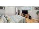 Comfortable bedroom boasts plantation shutters and entertainment center with mounted television at 1617 El Pardo Dr, Trinity, FL 34655