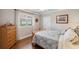 Cozy bedroom with hardwood floors, side table, large window with shades, and double door closet at 1617 El Pardo Dr, Trinity, FL 34655