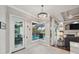 Dining area with pool view, chandelier, and access to an outdoor kitchen and pool area at 1617 El Pardo Dr, Trinity, FL 34655