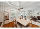 Bright dining room with a modern chandelier, neutral colors, and plantation shutters for privacy at 1617 El Pardo Dr, Trinity, FL 34655