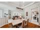 Open-concept dining area showcasing elegant lighting, neutral color palette and seamless flow to living spaces at 1617 El Pardo Dr, Trinity, FL 34655