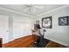 Comfortable exercise room features exercise equipment, hard wood flooring and memorabilia displays at 1617 El Pardo Dr, Trinity, FL 34655