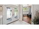 Stylish foyer with double doors, porcelain tile floors, and a glimpse into a home office with wood floors at 1617 El Pardo Dr, Trinity, FL 34655