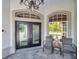 Close up of front door with sidelights and seating at 1617 El Pardo Dr, Trinity, FL 34655