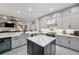 Modern kitchen features a large island, stainless steel appliances, gray cabinets and quartz countertops at 1617 El Pardo Dr, Trinity, FL 34655