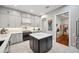 Modern kitchen design featuring a center island with white countertops, gray cabinets, and stainless steel appliances at 1617 El Pardo Dr, Trinity, FL 34655