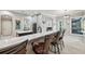 Spacious kitchen with island seating, granite countertops, stainless steel appliances, and modern gray cabinetry at 1617 El Pardo Dr, Trinity, FL 34655