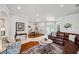 Inviting living room features a leather sofa, hardwood floors, neutral decor, and lots of natural light at 1617 El Pardo Dr, Trinity, FL 34655