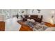Spacious living room featuring wood floors, a leather sectional sofa, and elegant decor at 1617 El Pardo Dr, Trinity, FL 34655