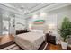 Bright main bedroom showcases a king-size bed, tray ceiling, wood floors, and matching dressers and nightstands at 1617 El Pardo Dr, Trinity, FL 34655