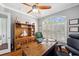 Spacious home office features a large window with custom shutters, hardwood floors, and wooden accents at 1617 El Pardo Dr, Trinity, FL 34655