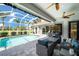 Relaxing pool with comfortable patio seating, ceiling fans and view of the lush backyard at 1617 El Pardo Dr, Trinity, FL 34655