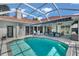 Inviting pool area has ample seating, an awning for shade and a screened in entertainment space at 1617 El Pardo Dr, Trinity, FL 34655