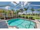 Sparkling pool is surrounded by a screen enclosure with lush landscaping and neighborhood golf course views at 1617 El Pardo Dr, Trinity, FL 34655