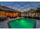 Beautiful backyard pool and patio area with outdoor kitchen and ample seating under the covered area at 1617 El Pardo Dr, Trinity, FL 34655