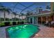 Beautiful backyard pool and patio area with ample seating and screened enclosure at 1617 El Pardo Dr, Trinity, FL 34655
