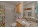 Bathroom featuring a single sink vanity and a shower with a floral curtain at 1710 Belleair Forest Dr # A, Belleair, FL 33756
