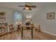 A cozy bedroom furnished with a desk and a ceiling fan at 1710 Belleair Forest Dr # A, Belleair, FL 33756