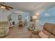 Cozy dining area with wood-look floors, chandelier, and natural light at 1710 Belleair Forest Dr # A, Belleair, FL 33756