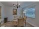 Charming dining room featuring a round table, seating for four, and a vintage chandelier at 1710 Belleair Forest Dr # A, Belleair, FL 33756