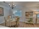 Charming dining area featuring wood-look floors, a round table, and neutral decor at 1710 Belleair Forest Dr # A, Belleair, FL 33756