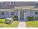 Close-up view of the entrance of the townhome featuring a green front door at 1710 Belleair Forest Dr # A, Belleair, FL 33756