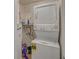 A laundry room with a stacked washer and dryer at 1710 Belleair Forest Dr # A, Belleair, FL 33756