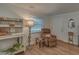 Comfortable living area with wood-look floors, plenty of natural light, and a cozy seating area at 1710 Belleair Forest Dr # A, Belleair, FL 33756