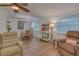 Inviting living and dining area with wood-look floors, neutral walls, and a ceiling fan at 1710 Belleair Forest Dr # A, Belleair, FL 33756