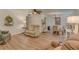 Inviting living room featuring wood-look floors, ceiling fan, and neutral decor at 1710 Belleair Forest Dr # A, Belleair, FL 33756