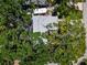 Birds-eye view of the house showing mature trees shading the property with a white roof at 1851 Oklahoma Ne Ave, St Petersburg, FL 33703