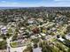 Aerial view of a residential neighborhood with lush greenery and views of water and city at 1851 Oklahoma Ne Ave, St Petersburg, FL 33703