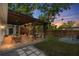 An outdoor living space featuring a covered patio with a dining table, bar, and seating area at 1851 Oklahoma Ne Ave, St Petersburg, FL 33703