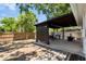 Backyard with a covered patio featuring a built-in grill and bar with table seating on the paved area at 1851 Oklahoma Ne Ave, St Petersburg, FL 33703
