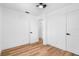 Neutral bedroom featuring hardwood floors, ceiling fan, closet, and doorway at 1851 Oklahoma Ne Ave, St Petersburg, FL 33703