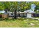 Charming single-story home featuring beautiful rock accents and a well-manicured lawn at 1851 Oklahoma Ne Ave, St Petersburg, FL 33703