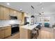 Modern kitchen with an island, stainless steel appliances, and wood cabinetry at 1851 Oklahoma Ne Ave, St Petersburg, FL 33703